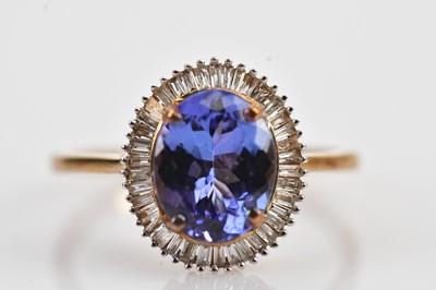 Lot 456 - A 9ct yellow gold diamond and tanzanite dress...