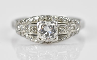 Lot 387 - A platinum diamond set dress ring, the central...