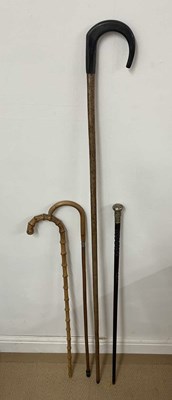 Lot 15 - Two bamboo style walking sticks, one with...