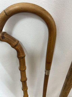 Lot 15 - Two bamboo style walking sticks, one with...
