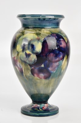 Lot 291 - WILLIAM MOORCROFT; a pedestal vase decorated...