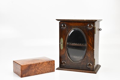 Lot 520 - An oak smoker's cabinet with glazed door,...