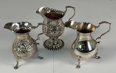 Lot 439 - Two George III hallmarked silver creamers,...