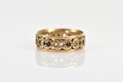 Lot 580 - A yellow metal ring, set with garnets and...