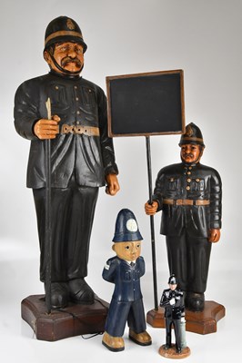 Lot 442 - Three wooden police figures, largest 108cm,...
