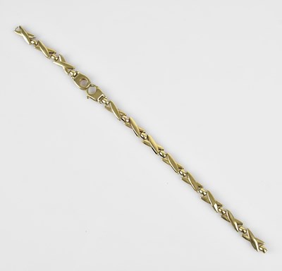 Lot 82 - A yellow metal bracelet stamped '9K', length...
