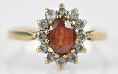 Lot 573 - A 9ct yellow gold cluster dress ring, set with...