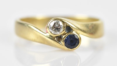 Lot 574 - A 9ct yellow gold diamond and sapphire...