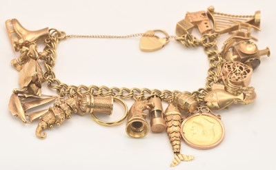 Lot 1395 - A 9ct yellow gold charm bracelet with padlock...