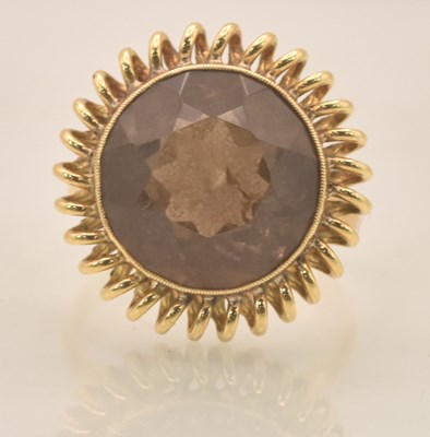 Lot 1253 - A yellow metal smoky quartz set dress ring,...