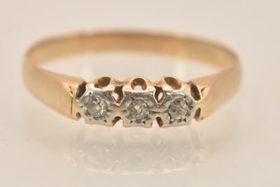Lot 1269 - A yellow metal diamond three stone ring, with...