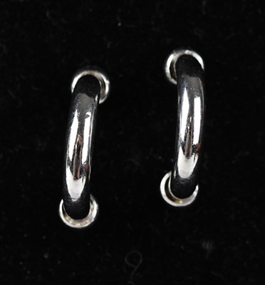 Lot 172 - A pair of platinum half hoop ear studs,...
