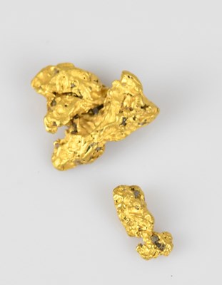 Lot 407 - Two yellow metal nuggets, test as 23.1kt gold...