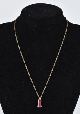 Lot 406 - A yellow metal ruby and diamond scrolling...