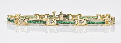 Lot 100 - A yellow and white metal diamond and emerald...