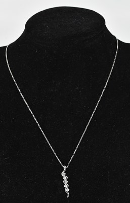 Lot 233 - A diamond set wave pendant stamped '750',...