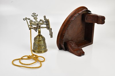 Lot 599 - A wall mounted brass bell, with a mahogany...