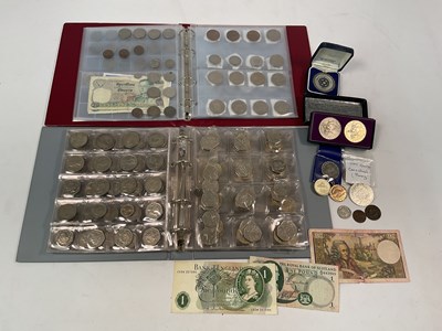 Lot 399 - Two folders of coins, to include twenty-five...