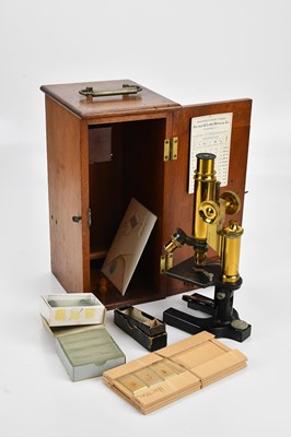 Lot 409 - BAUSCH & LOMB OPTICAL CO; a brass microscope,...