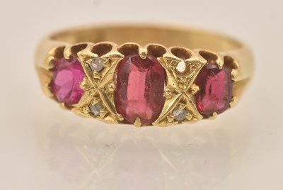 Lot 1301 - A yellow metal ruby and diamond set three...