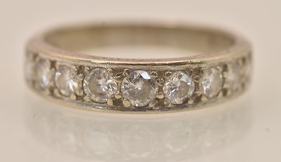 Lot 1211 - An 18ct white gold diamond half eternity ring,...