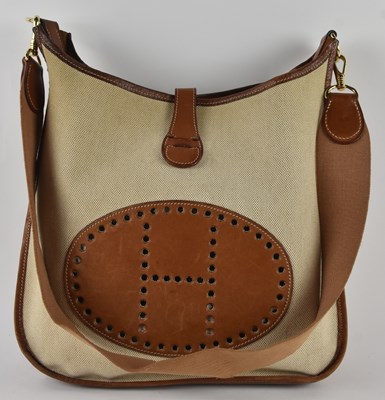 Lot 437 - HERMÈS; a cream canvas and tan leather...