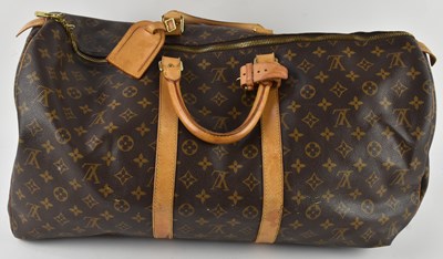 Lot 451 - LOUIS VUITTON; a vintage brown and tan leather...