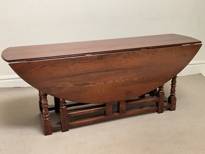 Lot 81 - A reproduction oak wake table in the manner of...