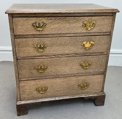 Lot 141 - An oak chest for four drawers on bracket feet,...