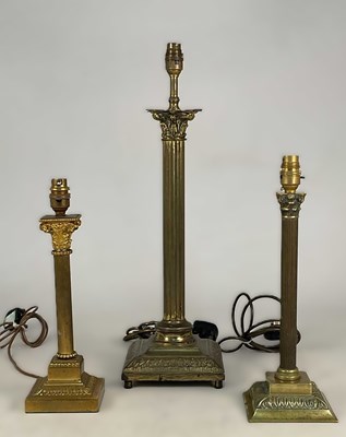 Lot 618 - Three decorative brass Corinthian column table...