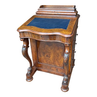 Lot 176 - A Victorian walnut Davenport with carved legs...