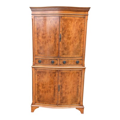Lot 90 - A 1950s yew wood cocktail cabinet, with a pair...