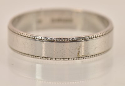 Lot 1259 - A 9ct white gold band ring, size U, approx 3.54g.