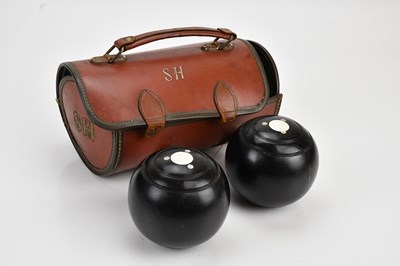 Lot 523 - A set of bowling balls, cased.