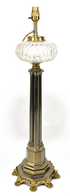 Lot 1526 - A Gothic inspired brass oil lamp with clear cut glass reservoir