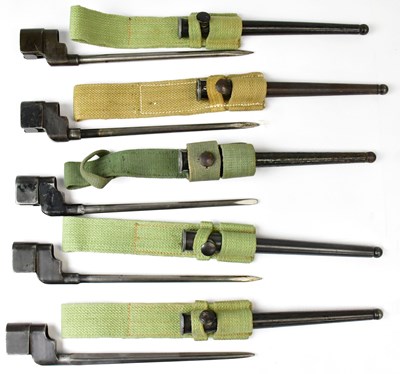 Lot 601 - Five spike bayonets with canvas frogs,...