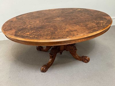 Lot 129 - A Victorian inlaid figured walnut oval loo...