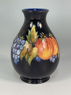 Lot 181 - MOORCROFT; a 'Fruit Vine' pattern vase, height...