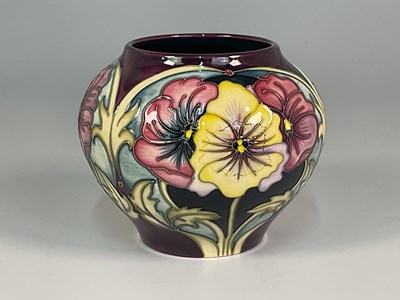 Lot 203 - MOORCROFT; a 'Pansy' pattern vase, designed by...