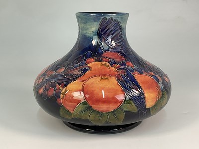 Lot 179 - MOORCROFT; a 'Finches' pattern vase designed...