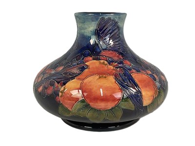 Lot 216 - MOORCROFT; a 'Finches' pattern vase, designed...