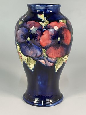 Lot 177 - MOORCROFT; a 'Pansy' pattern vase, height 24cm.