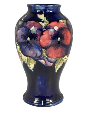 Lot 218 - MOORCROFT; a 'Pansy' pattern vase, height 24cm.