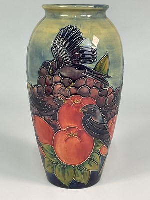 Lot 211 - MOORCROFT; a 'Finches and Fruit' pattern vase,...