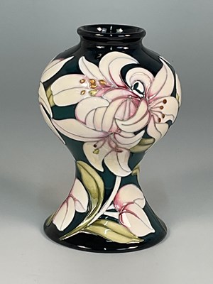 Lot 191 - MOORCROFT; a 'Lily' pattern vase, designed by...