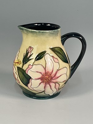 Lot 235 - MOORCROFT; a 'Pink Hibiscus' pattern jug,...