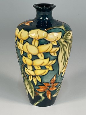 Lot 214 - MOORCROFT; a 'Wisteria' pattern vase, designed...