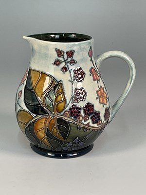 Lot 216 - MOORCROFT; a 'Bramble' pattern jug, designed...