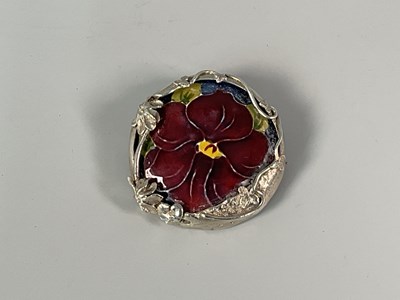 Lot 218 - MOORCROFT; a 'Pansy' brooch with a sterling...