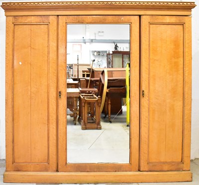 Lot 92 - A Victorian maple triple-door wardrobe, with...